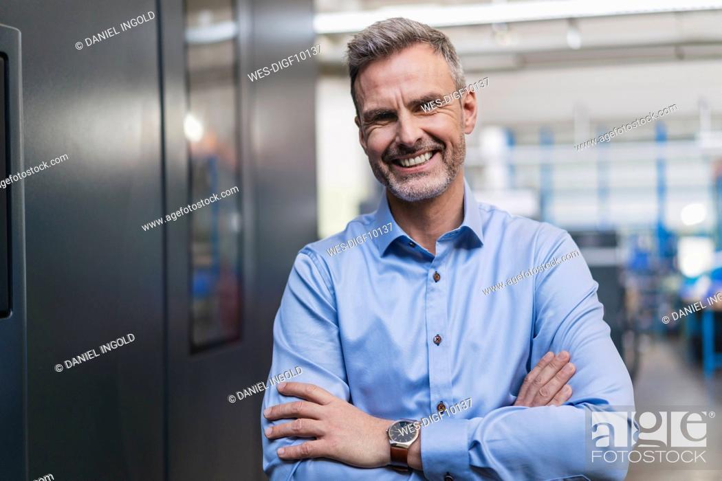Stock Photo: Portrait of a confident businessman in a factory.