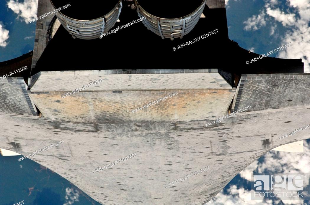 Stock Photo: This view of the aft underside of the space shuttle Discovery was provided by an Expedition 26 crew member during a survey of the approaching STS-133 vehicle.