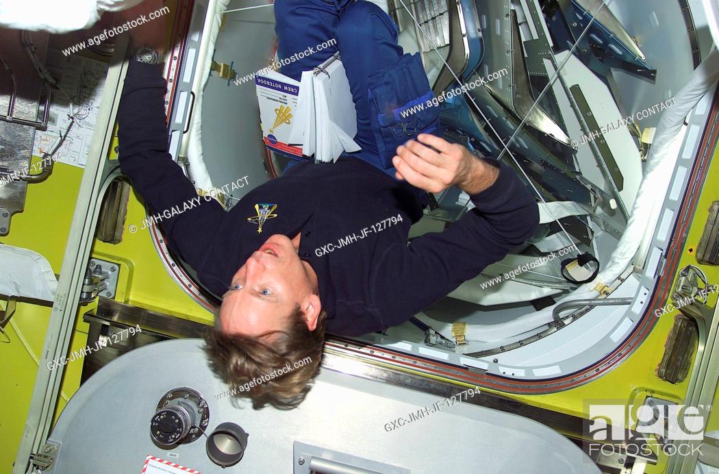 Stock Photo: Astronaut Michael L. Gernhardt, STS-104 mission specialist, floats in the Quest Airlock prior to getting suited for the second of three scheduled STS-104 space.