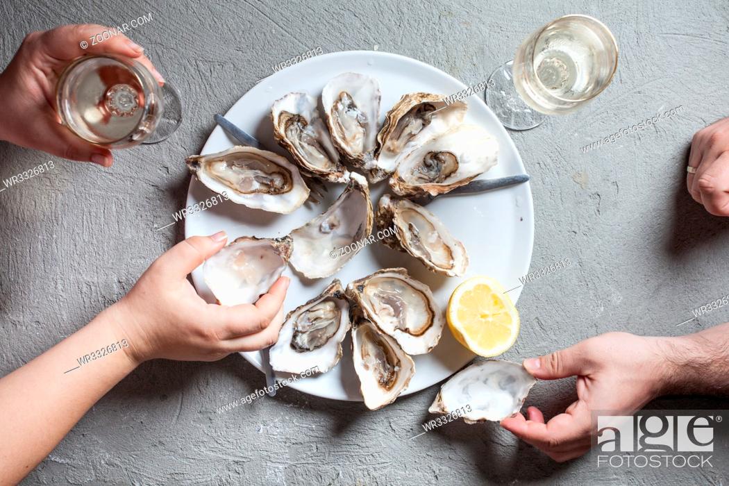 Stock Photo: Delicious oysters with slice of lemon and glasses of white wine, top view.