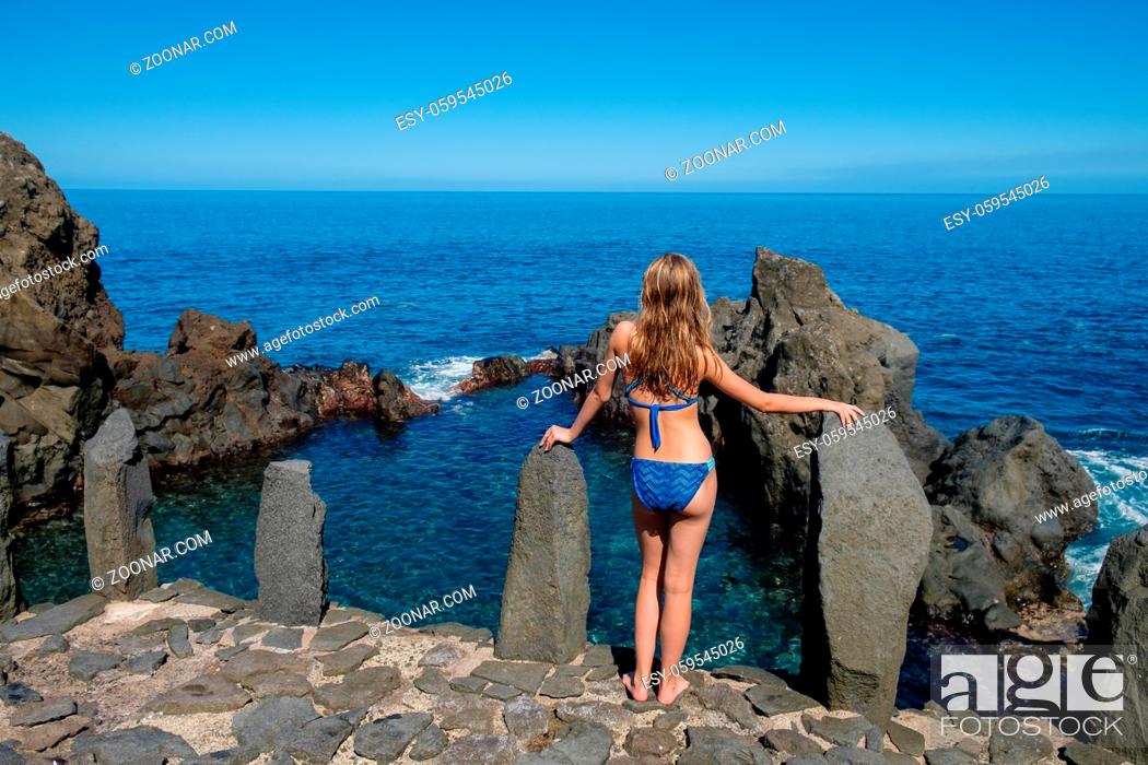 Stock Photo: beautiful teen age girl in blue bikini resting in natural ocean swimming pool. outdoor shot on Tenerife island. Canarian islands.