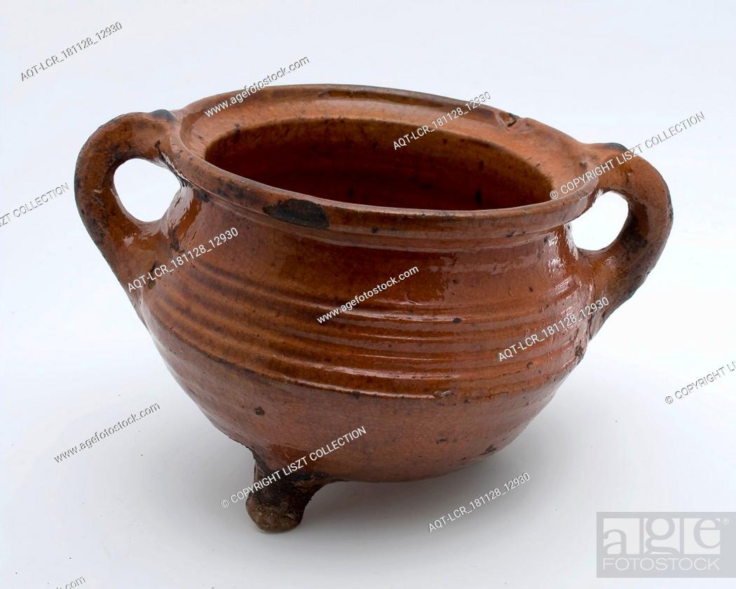 Stock Photo: Pottery cooking pot, grape-model, red shard with lead glaze, two vertical sausages, on three legs, cooking pot crockery container kitchenware earth discovery.