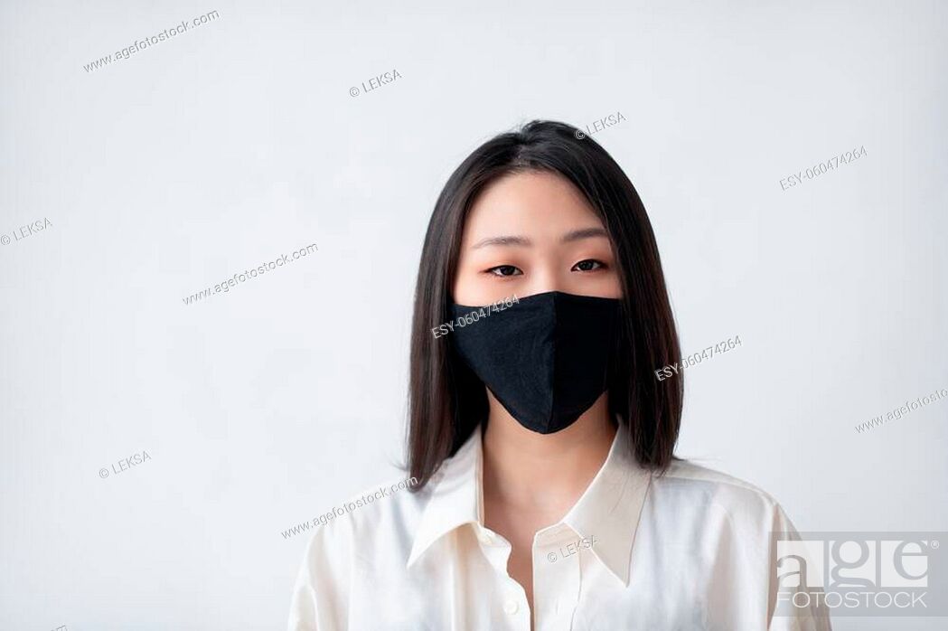 A young Asian Korean girl in a stylish cotton mask her face to protect against viruses and..., Stock Photo, Picture And Low Budget Royalty Free Image. ESY-060474264 | agefotostock