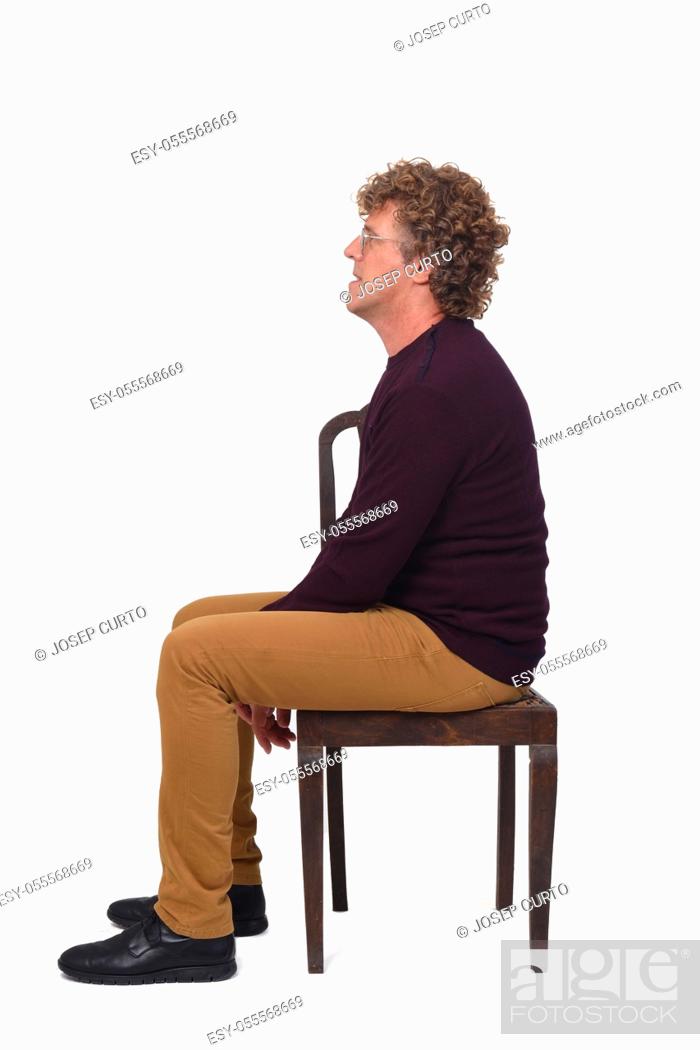Stock Photo: side view of a man sitting on white background.