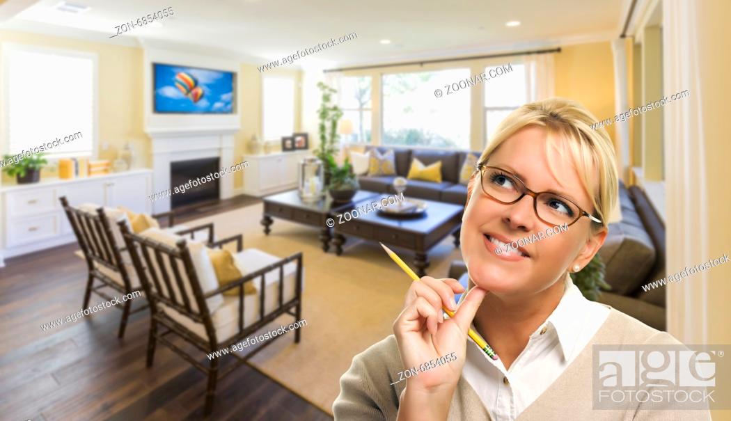 Stock Photo: Attractive Daydreaming Woman with Pencil Inside Beautiful Living Room.