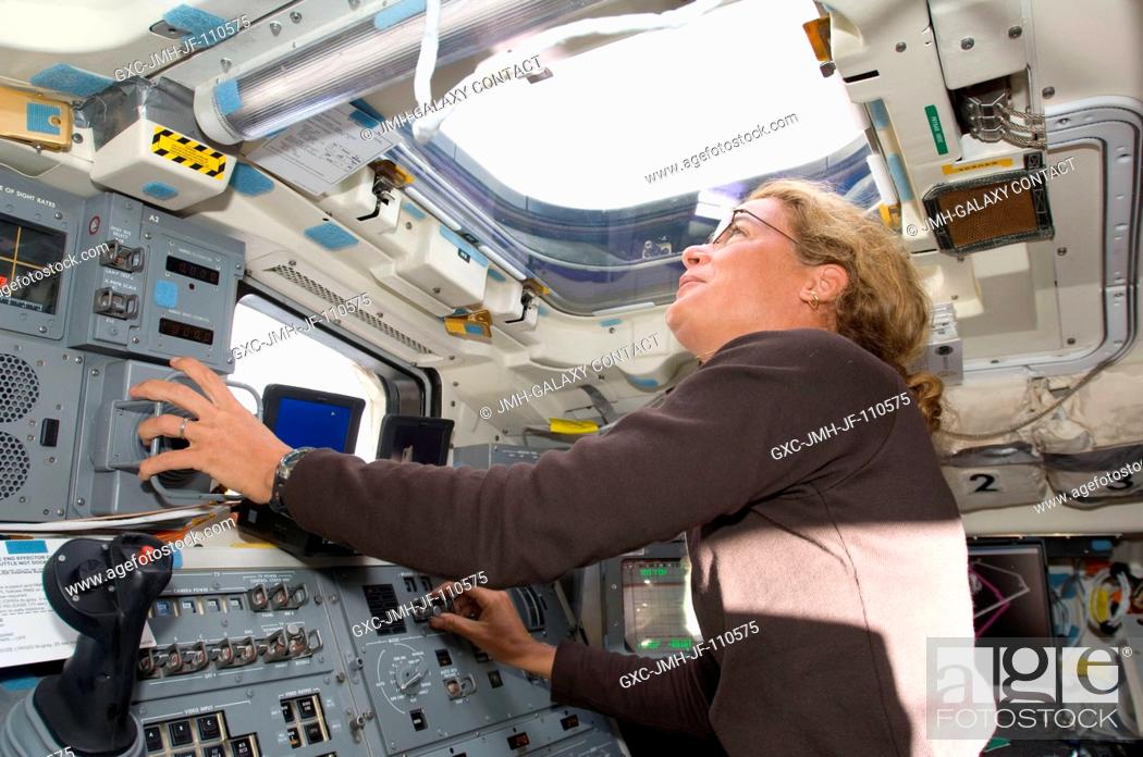 Stock Photo: Canadian Space Agency astronaut Julie Payette, STS-127 mission specialist, looks through an overhead window while operating controls on the aft flight deck of.