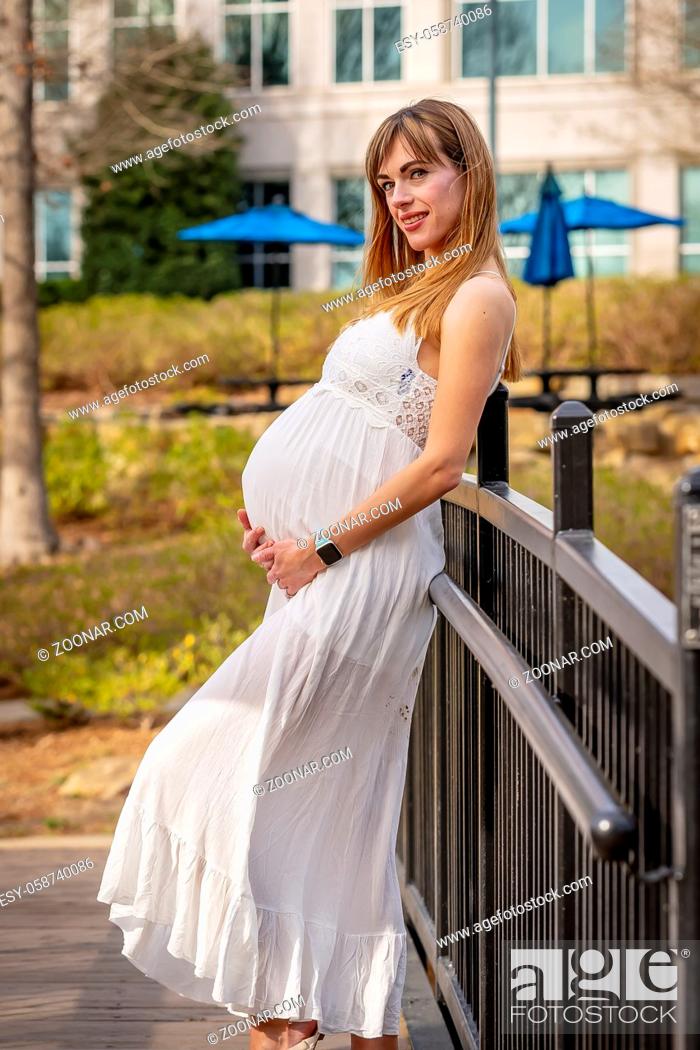Stock Photo: A beautiful expectant mother poses in an outdoor environment.