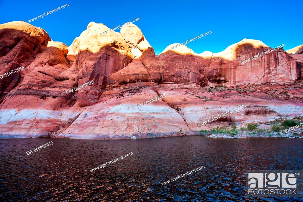 Stock Photo: The Colorado River and Antelope Canyon. Grandiose cliffs - red sandstone outcroppings. Tour on a tourist boat on an artificial reservoir Lake Powell.