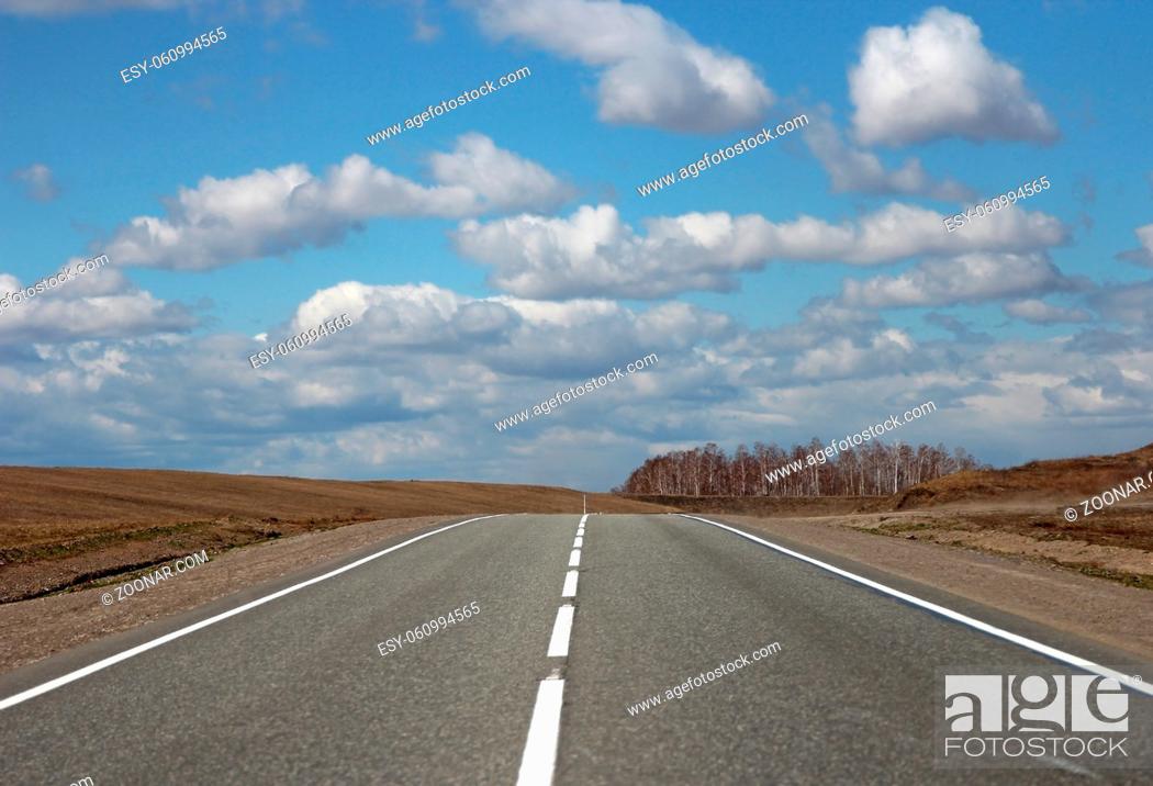 Photo de stock: Asphalt road and clouds on blue sky in sunny day.