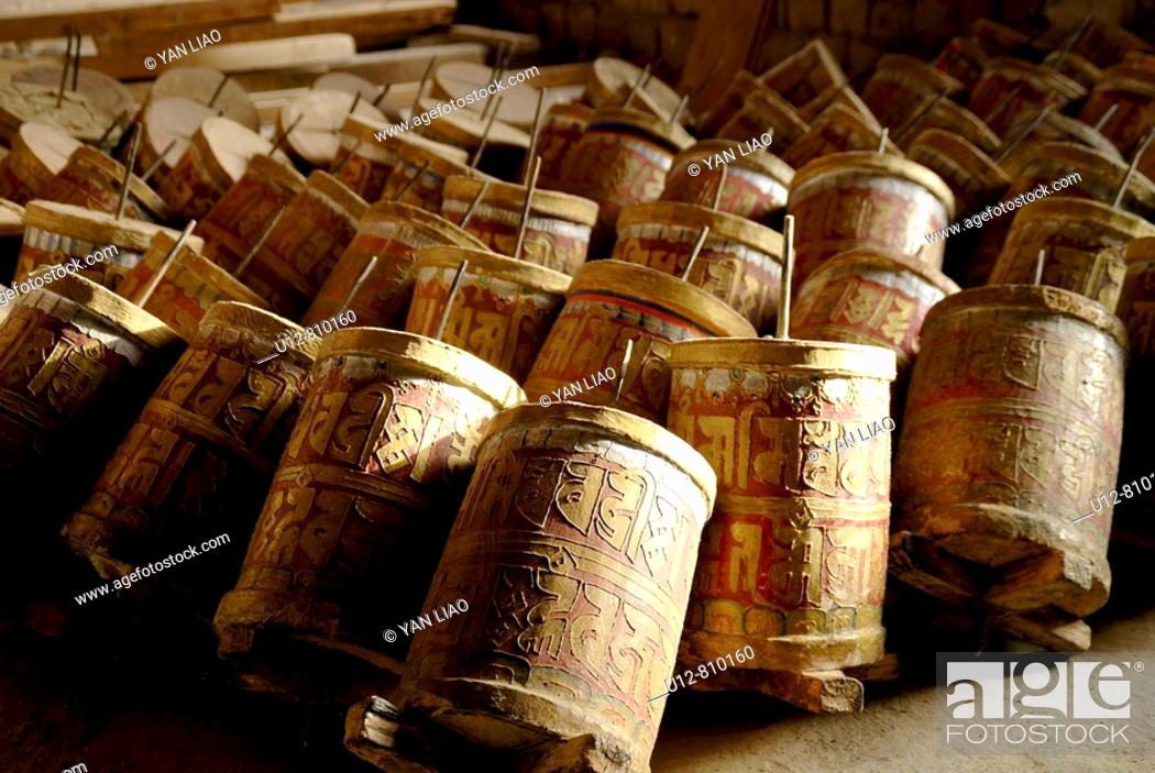 Stock Photo: A cylinder containing or inscribed with prayers or litanies that is revolved on its axis in devotions, especially by Tibetan Buddhists.