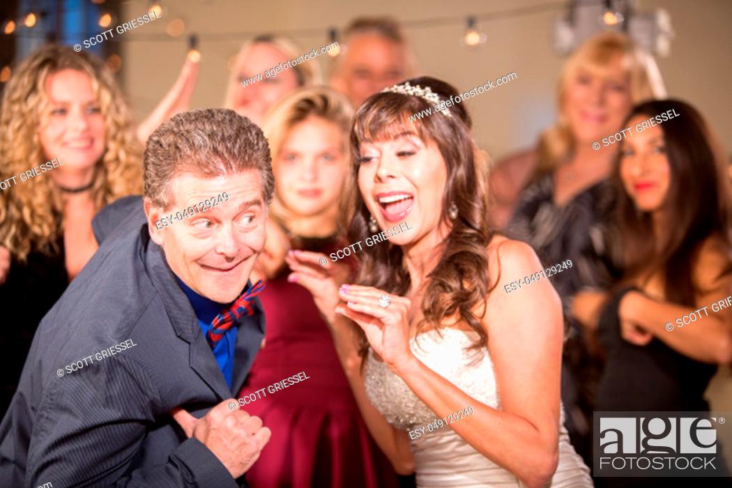 Stock Photo: Bride and Man Doing Chicken Dance at a Wedding.