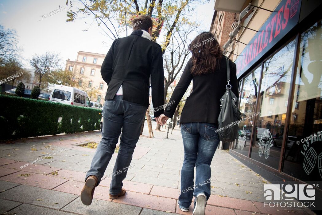 Stock Photo: Couple walking in street.