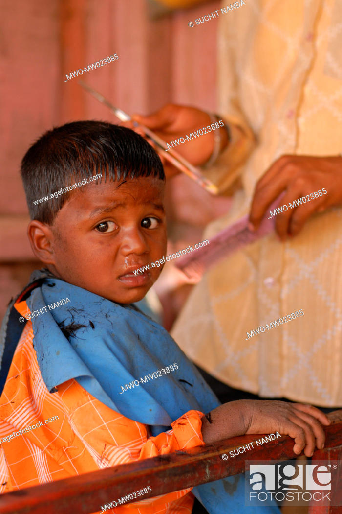 A child is having a hair cut at a barber's saloon, in a village fair or  'haat', near Nagpur, Stock Photo, Picture And Rights Managed Image. Pic.  MWO-MW023885 | agefotostock