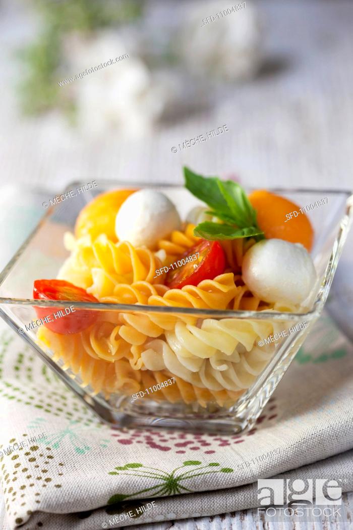 Stock Photo: Pasta salad with tomatoes, melon and mozzarella balls.