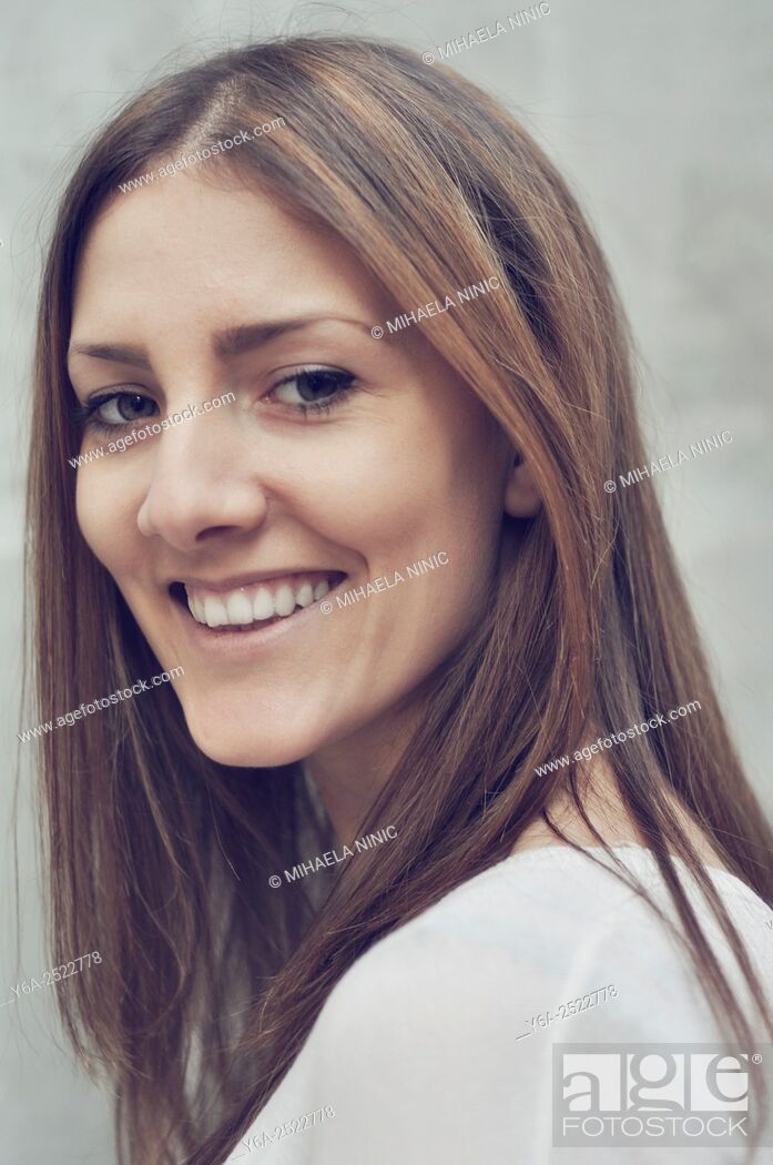 Stock Photo: Portrait of a smiling young woman.