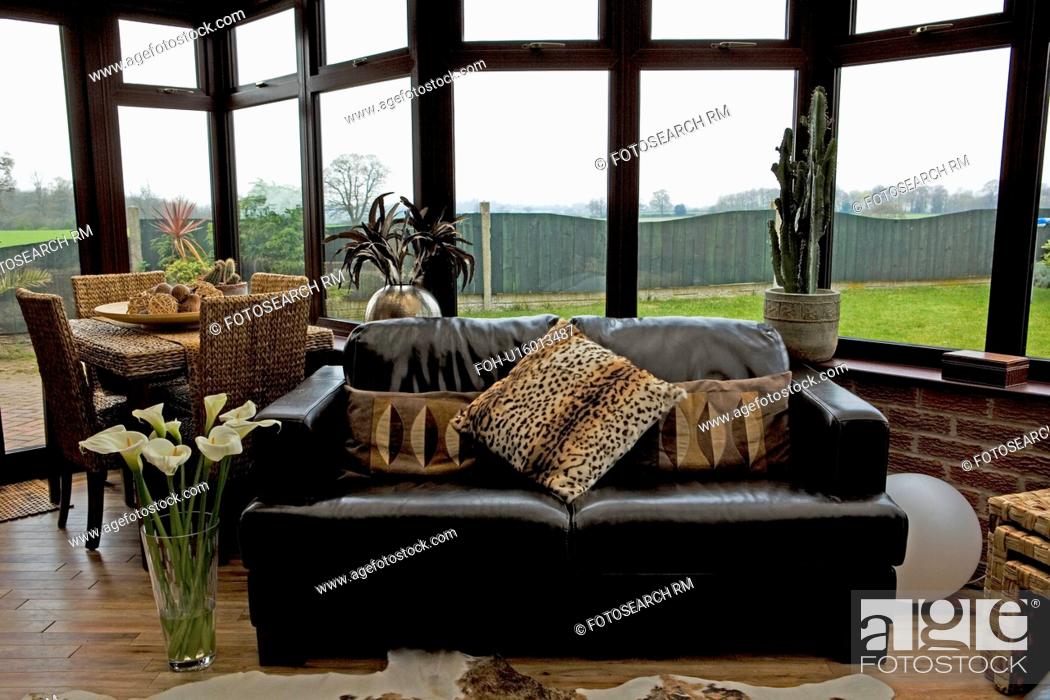 Animalprint Cushions On Black Leather, Black Leather Sofa Cushion