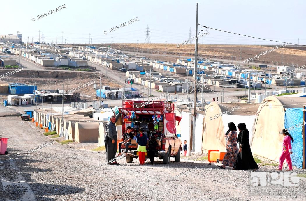 Stock Photo: A car selling household objects is parked between tents in the Mamilian refugee camp in the Dohuk region, Iraq, 19 October 2016.