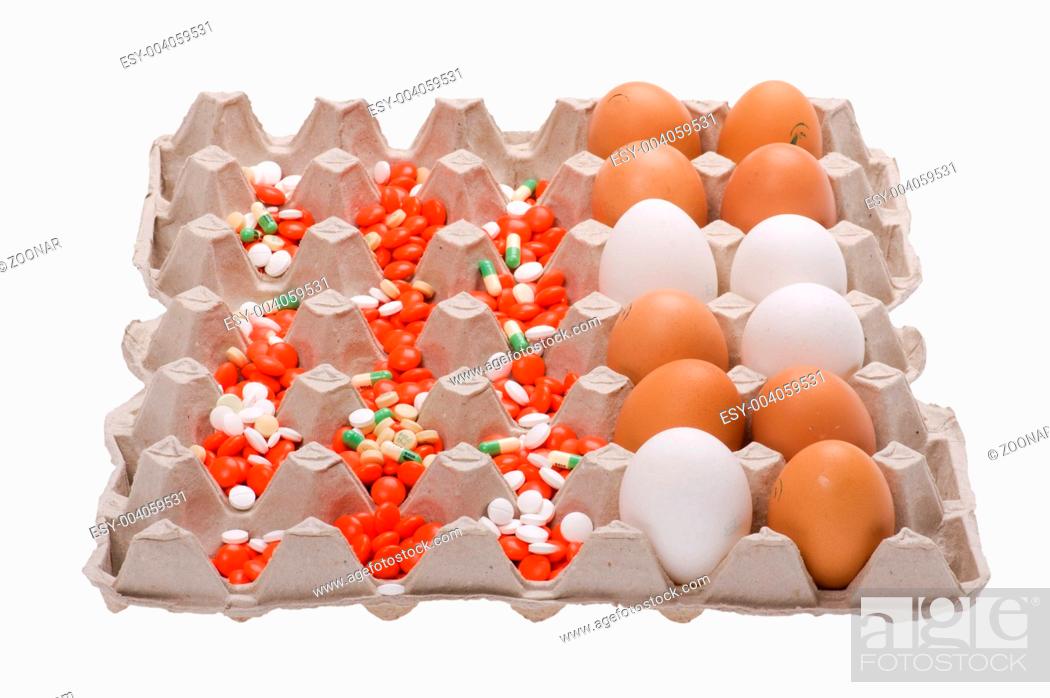 Photo de stock: egg and medical tablet on box.