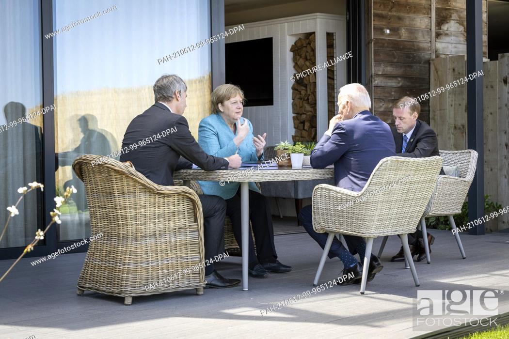 Stock Photo: HANDOUT - 12 June 2021, United Kingdom, St.Ives: German Chancellor Angela Merkel (CDU) and US President Joe Biden (2nd from right) sit with their foreign policy.