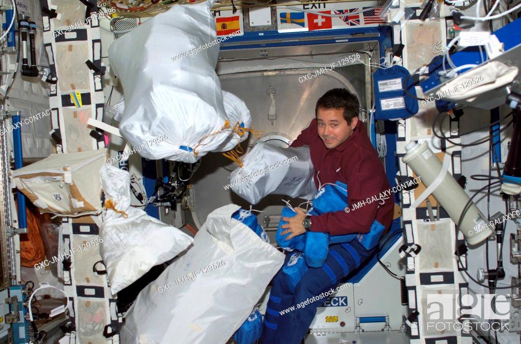 Stock Photo: Astronaut Daniel W. Bursch, Expedition Four flight engineer, is photographed among stowage bags in the Destiny laboratory on the International Space Station.