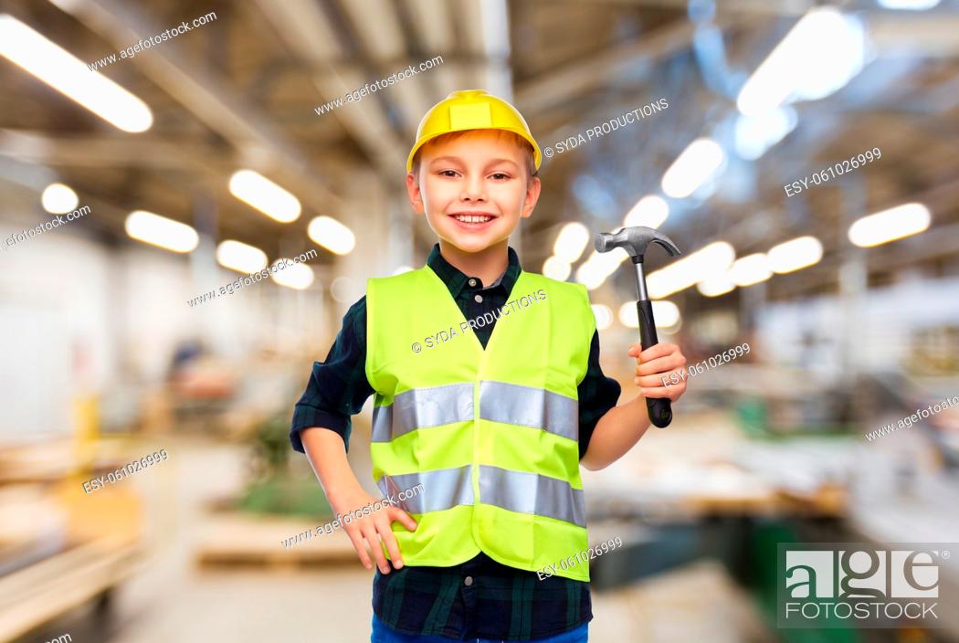 Stock Photo: boy in protective helmet and vest with hammer.
