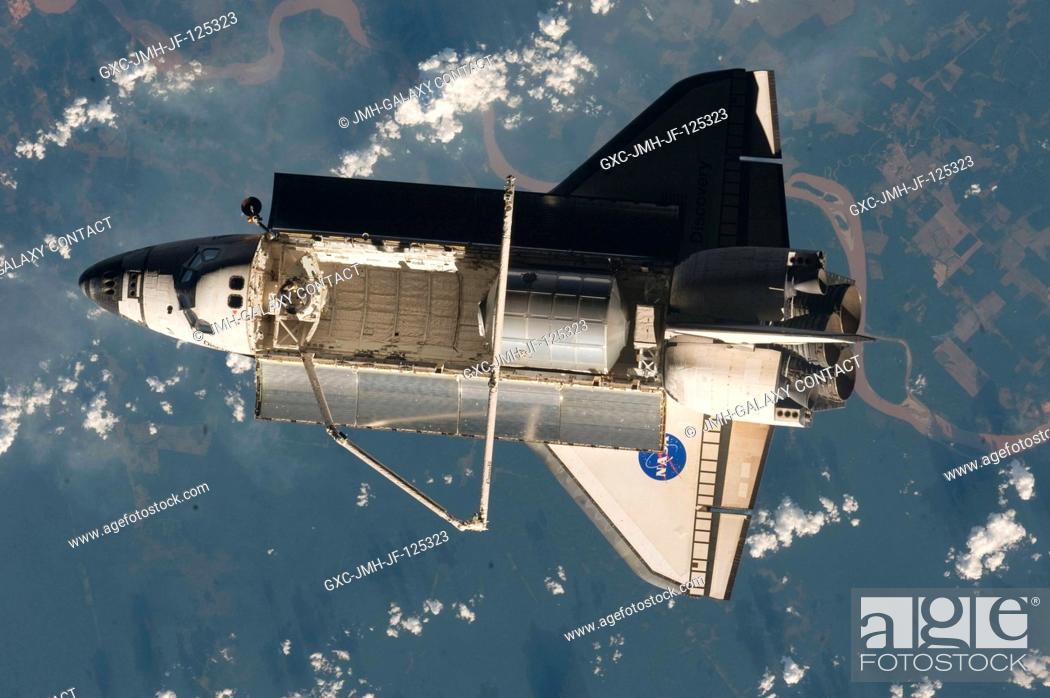 Stock Photo: Backdropped by a colorful part of Earth, Space Shuttle Discovery (STS-128) is featured in this image photographed by an Expedition 20 crew member on the.