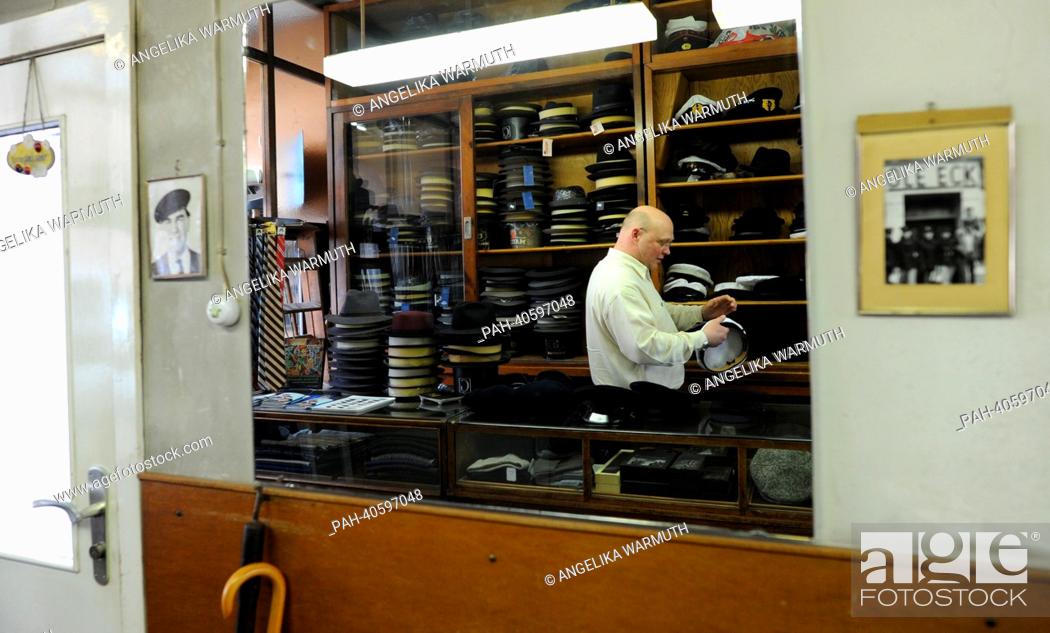 Stock Photo: Cap maker Lars Kuentzel stands behind the counter in Hamburg, Germany, 15 March 2013. Since 1892 the cap shop Eisenberg produces and sells caps called Altona.