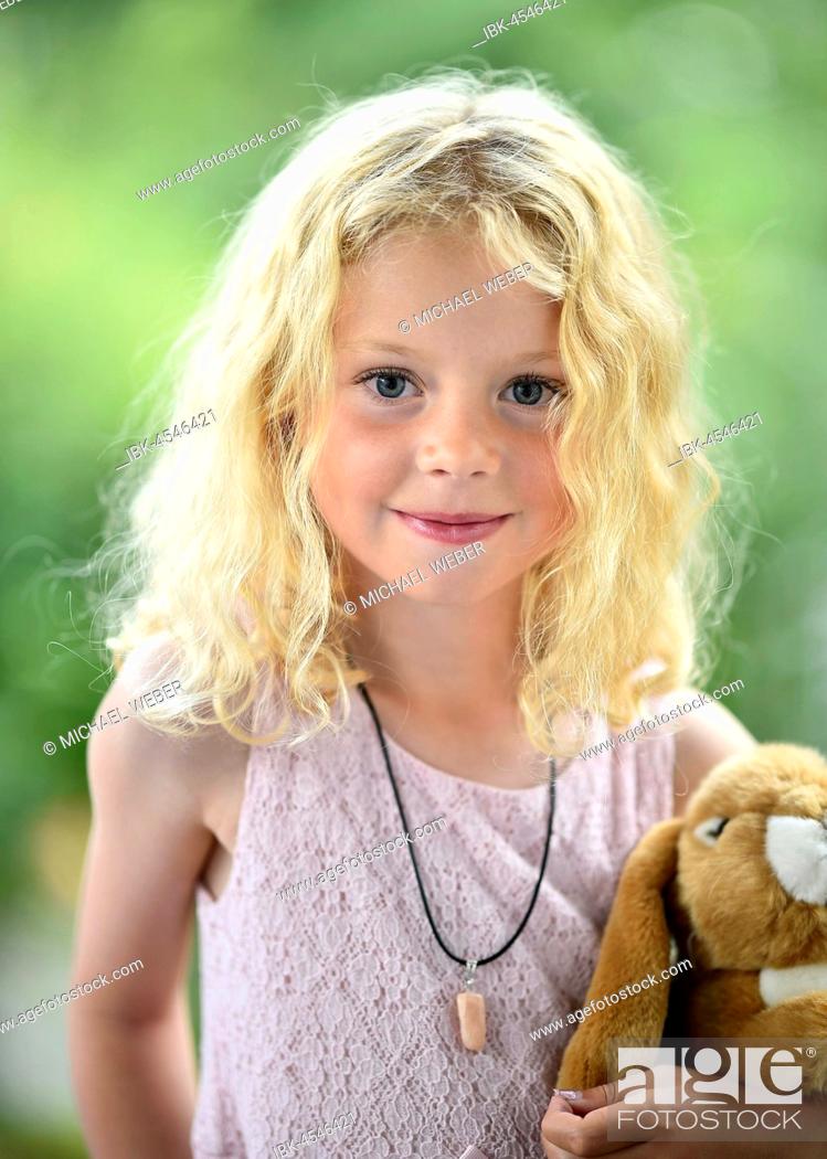 Little girl with blonde hair and cuddly toy, Sweden, Stock Photo, Picture  And Royalty Free Image. Pic. IBK-4546421 | agefotostock