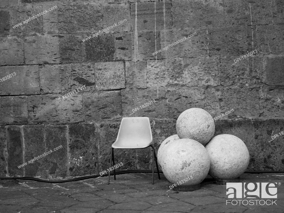 Stock Photo: Chair, round rocks, Castle Nuovo, Naples, Italy.