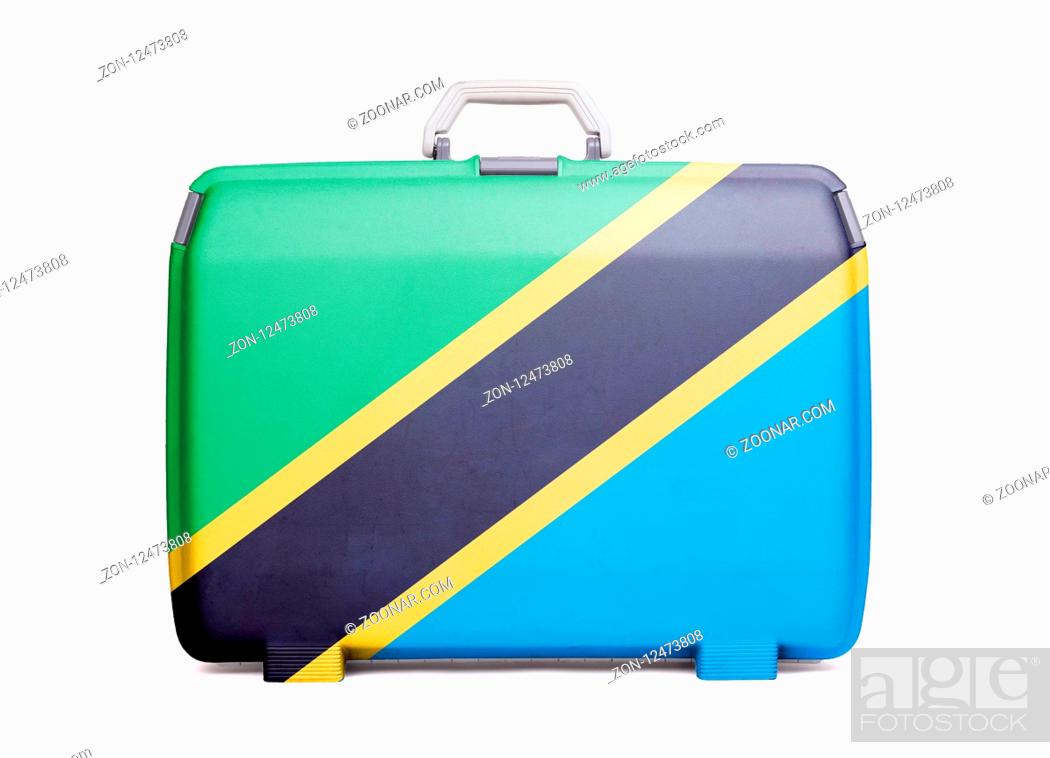 Stock Photo: Used plastic suitcase with stains and scratches, printed with flag, Tanzania.