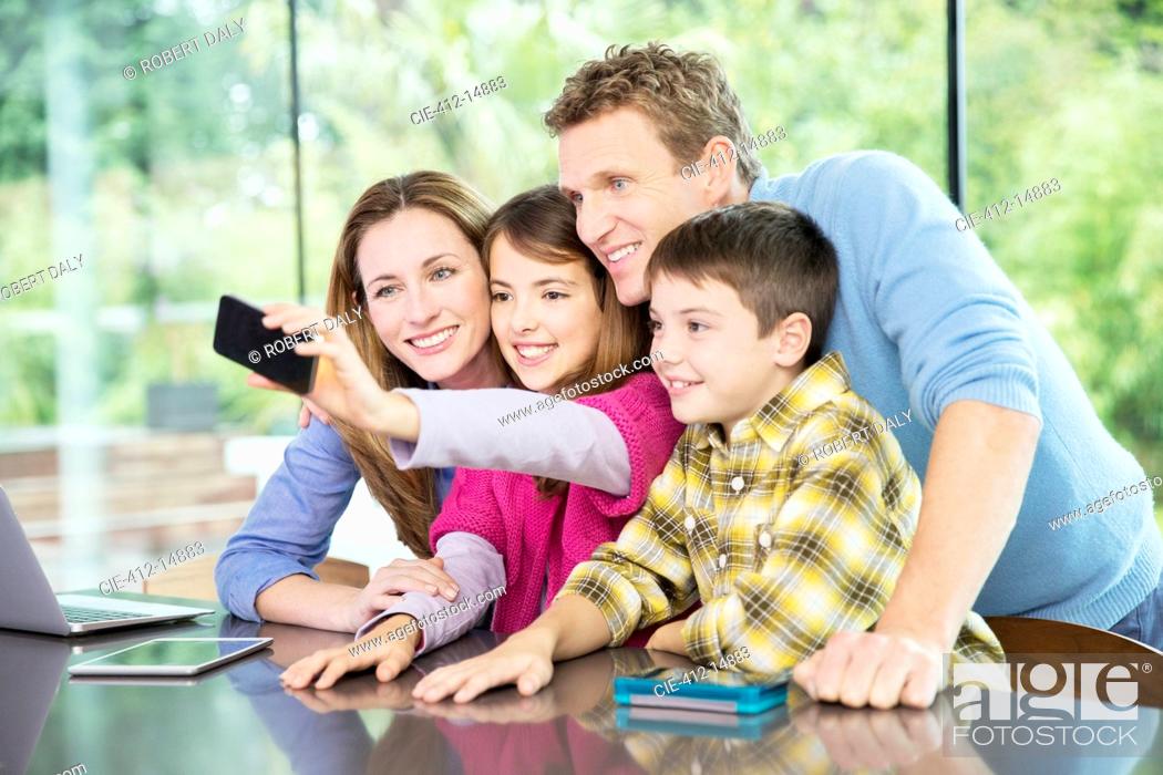Stock Photo: Family taking cell phone picture together.
