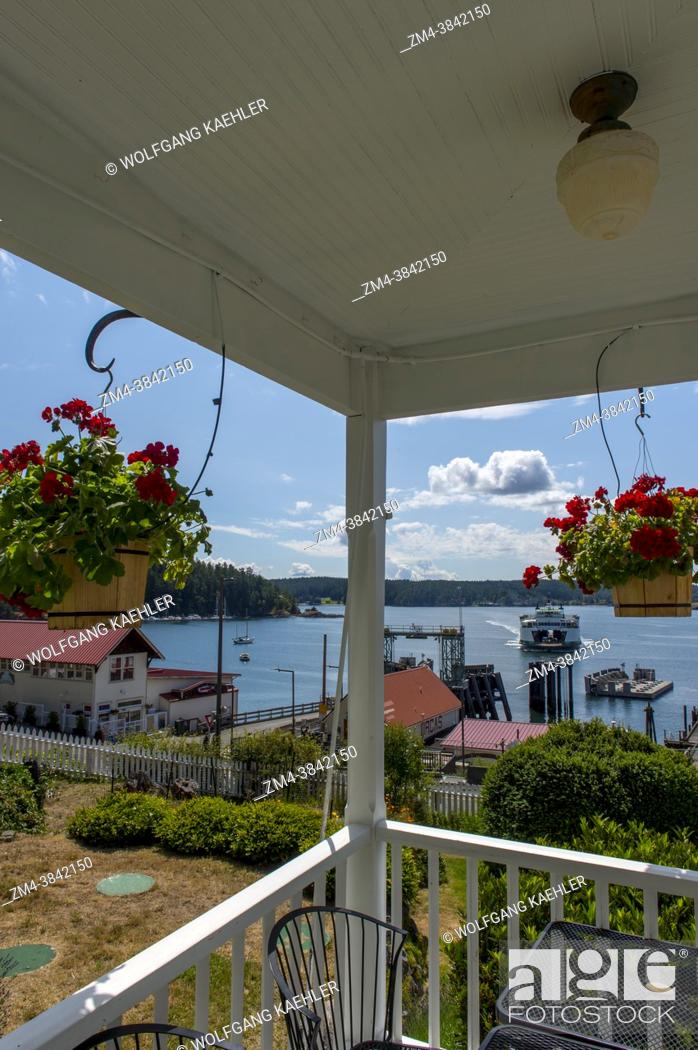 Stock Photo: View of the Orcas Island Ferry Landing with an approaching ferry from the Orcas Hotel, a historic inn and cafe built 1904.