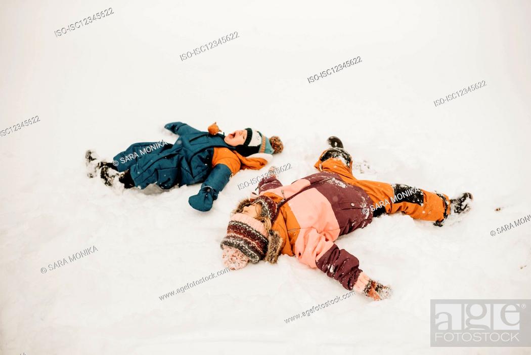 Stock Photo: Canada, Ontario, Brother (12-17 months) and sister (2-3) doing snow angels.