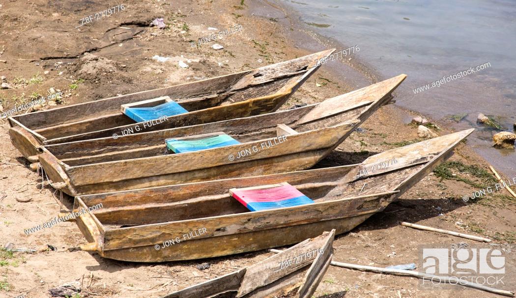 Stock Photo: Three cayucos or fishing boats on the shore of Lake Atitilan at San Antonio Palopó, Guatemala.