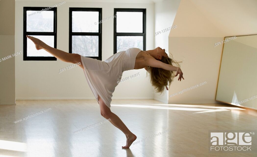Stock Photo: Side profile of a mid adult woman dancing.