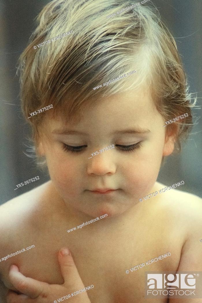 Stock Photo: Portrait of a 2 years old boy with his eyes closed.