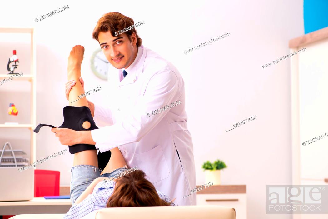Stock Photo: Young female patient visiting male doctor traumatologist.