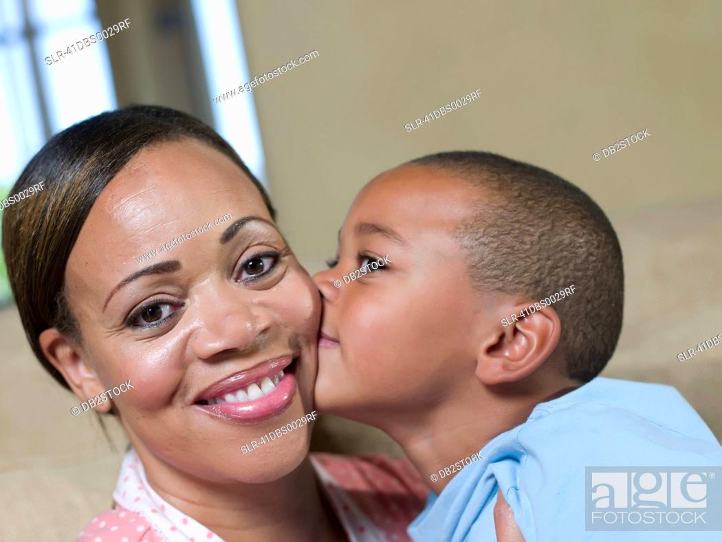 Stock Photo: Boy kissing mothers cheek.