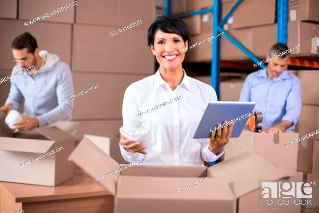 Stock Photo: Warehouse workers packing up boxes.