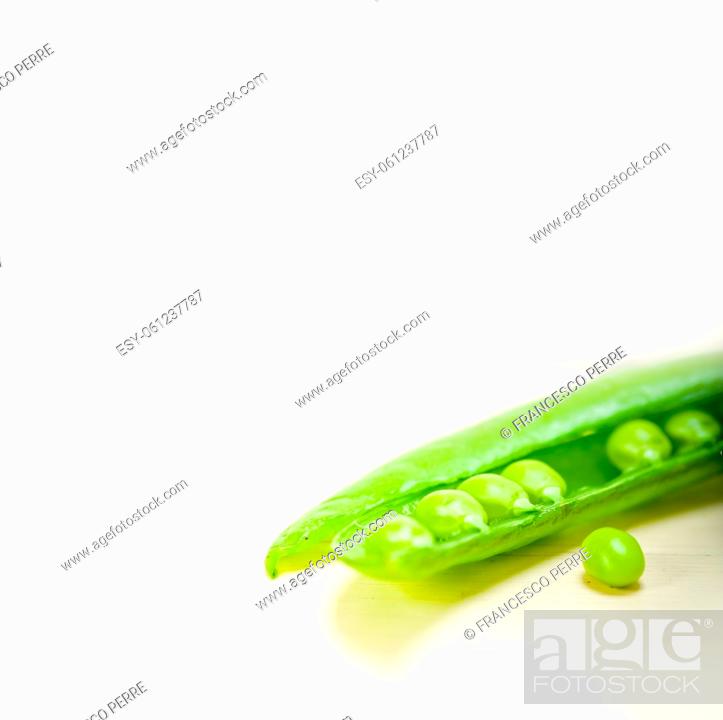 Stock Photo: hearthy fresh green peas over a rustic wood table.
