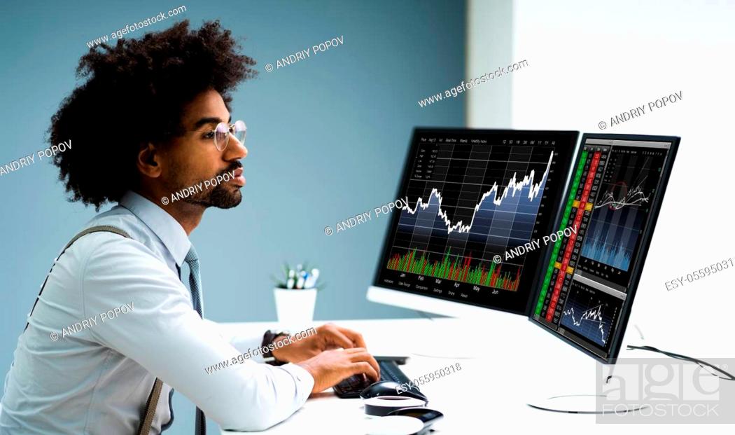 Stock Photo: Stock Exchange Analyst Using Multiple Computer Screens.