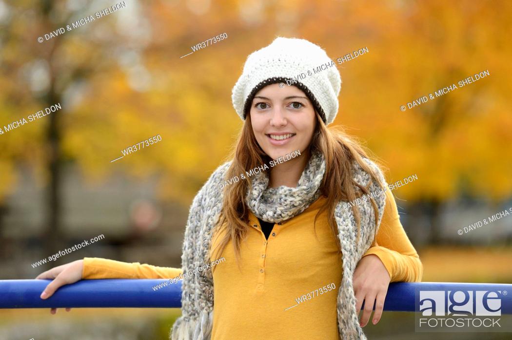 Stock Photo: Smiling young woman in autumn, portrait.