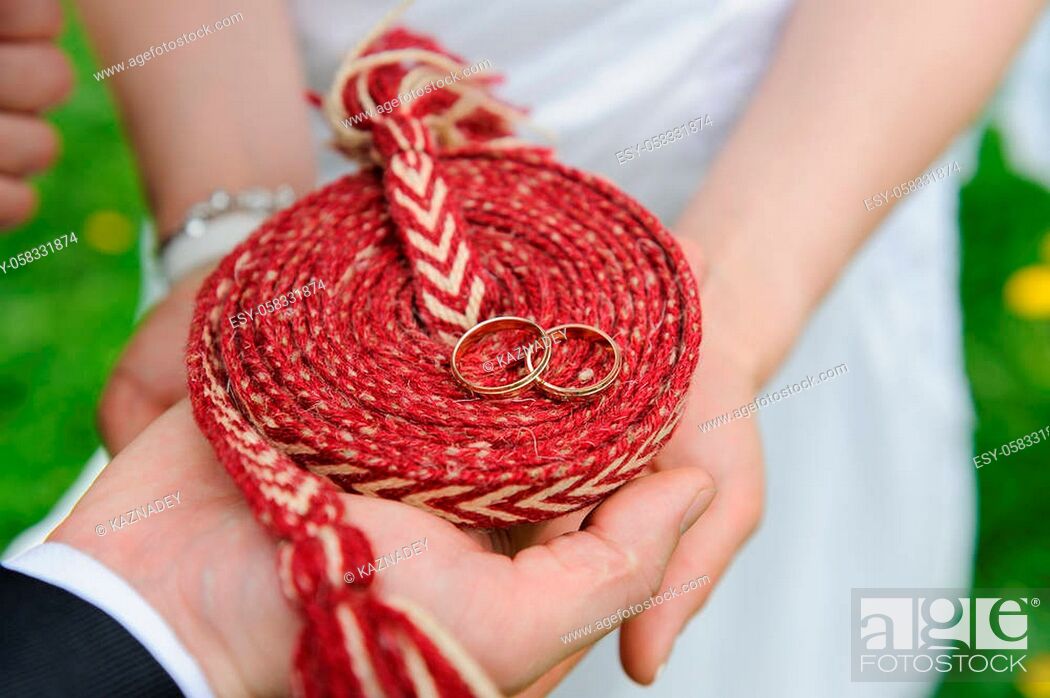 Stock Photo: Close-up a bride and groom covers of each other's hands with rings. Wedding photograph of a young couple of lovers who are just married.