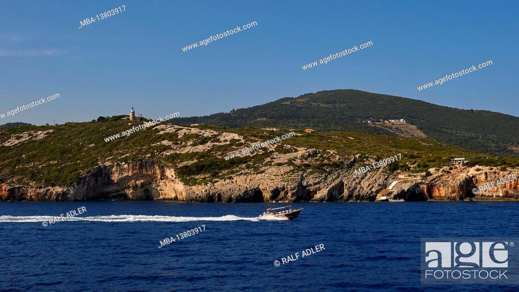 Stock Photo: Ionian Islands, Zakynthos, northeast coast, Blue Caves, Blue Grottoes, morning light, excursion boat drives quickly from left to right, behind the grottos.