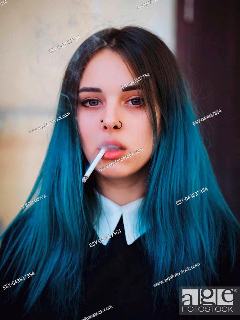 Emo girl smoking cigarette. Young student or pupil with blue colorful dyed  hair, hat, piercing, Stock Photo, Picture And Low Budget Royalty Free  Image. Pic. ESY-043837354 | agefotostock