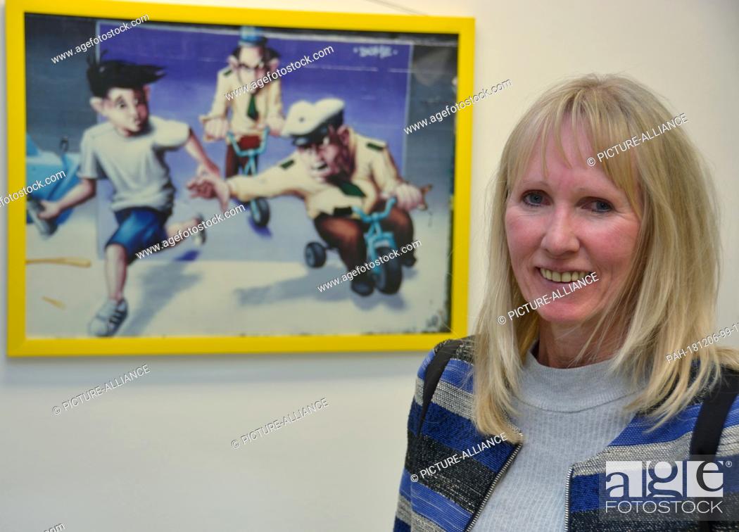 Stock Photo: 27 November 2018, Hessen, Hanau: Chief Detective Ursula Elmas, head of the ""Sprayer"" department at the Hanau police, is standing in front of a picture that.