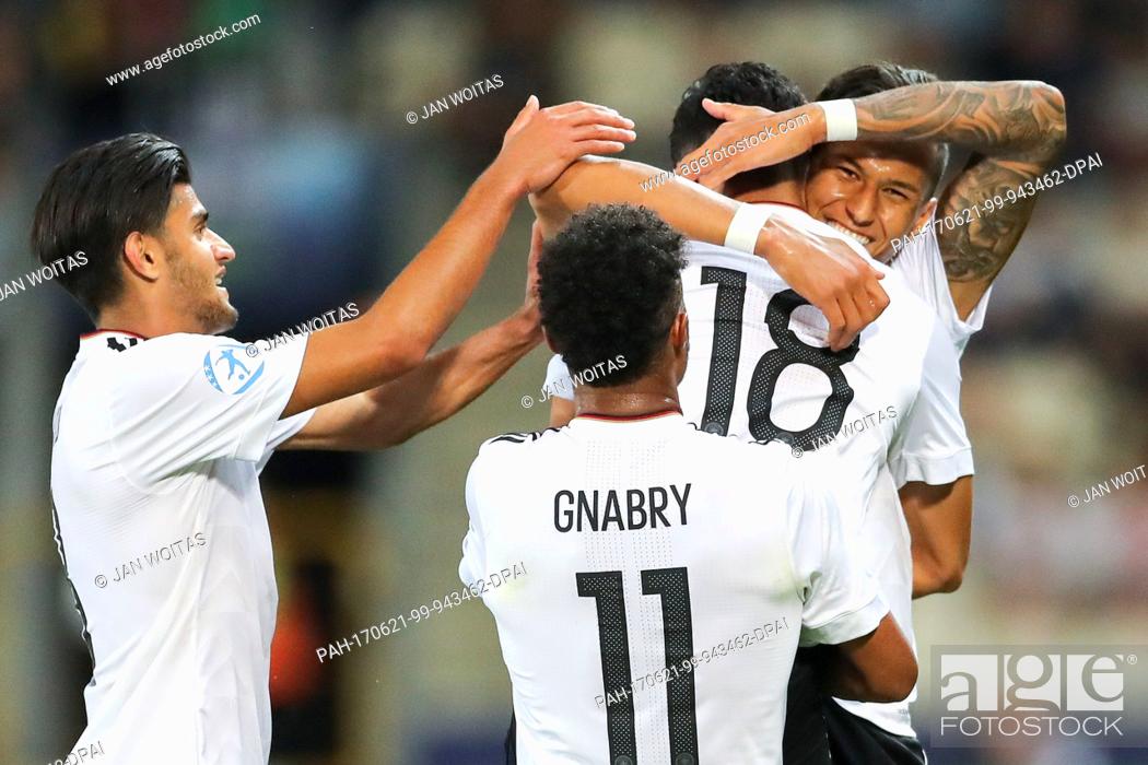 Stock Photo: The German players Nadiem Amiri (M), Serge Gnabry and Mahmoud Dahoud (L) cheer over Amiri's 3-0 score during the men's U21 European Cup Group C match between.