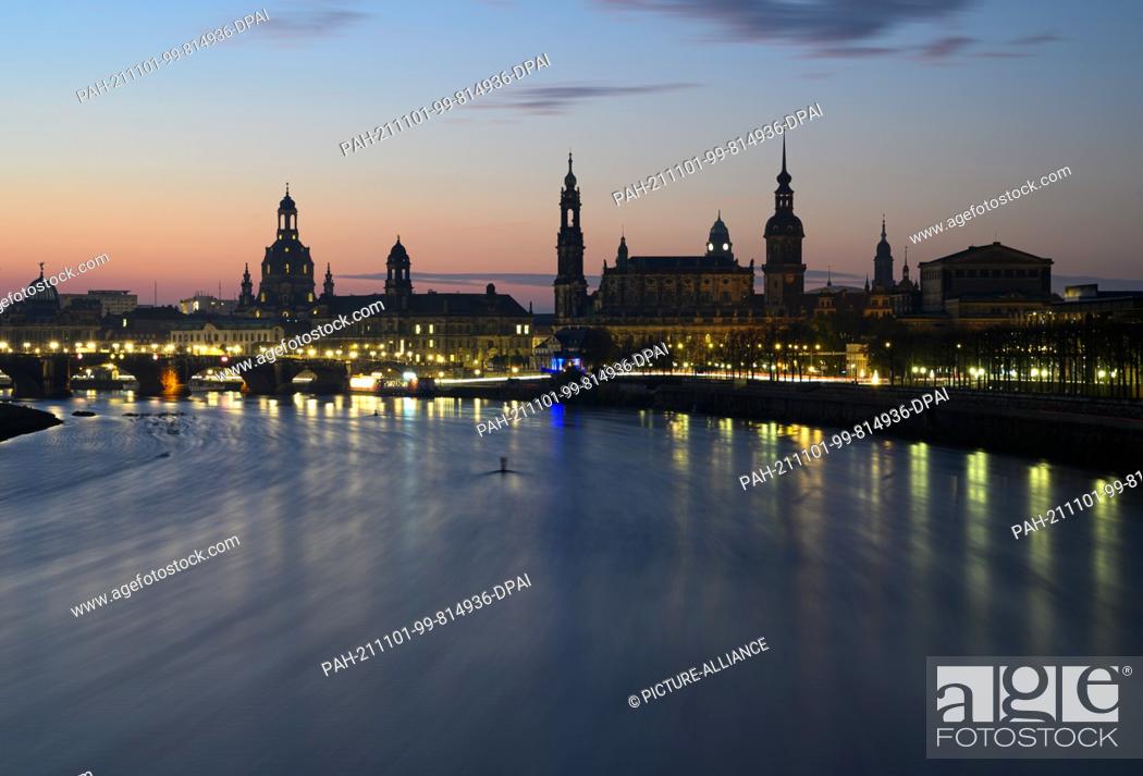 Stock Photo: 01 November 2021, Saxony, Dresden: Panoramic view in the morning onto the historical Old Town at the river Elbe with the dome of the Academy of Arts (l-r).