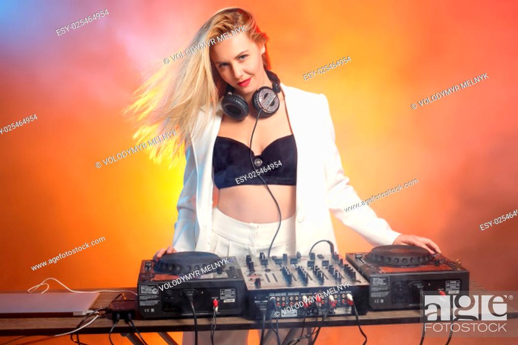 Beautiful blonde DJ girl on decks on the party on the background of orange  smoke, Stock Photo, Picture And Low Budget Royalty Free Image. Pic.  ESY-025464954 | agefotostock