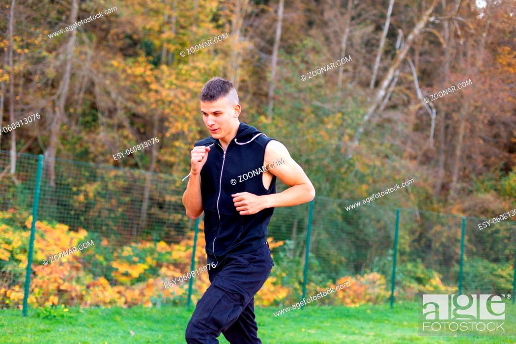 Stock Photo: Young man jogging in the morning outdoor in nature.